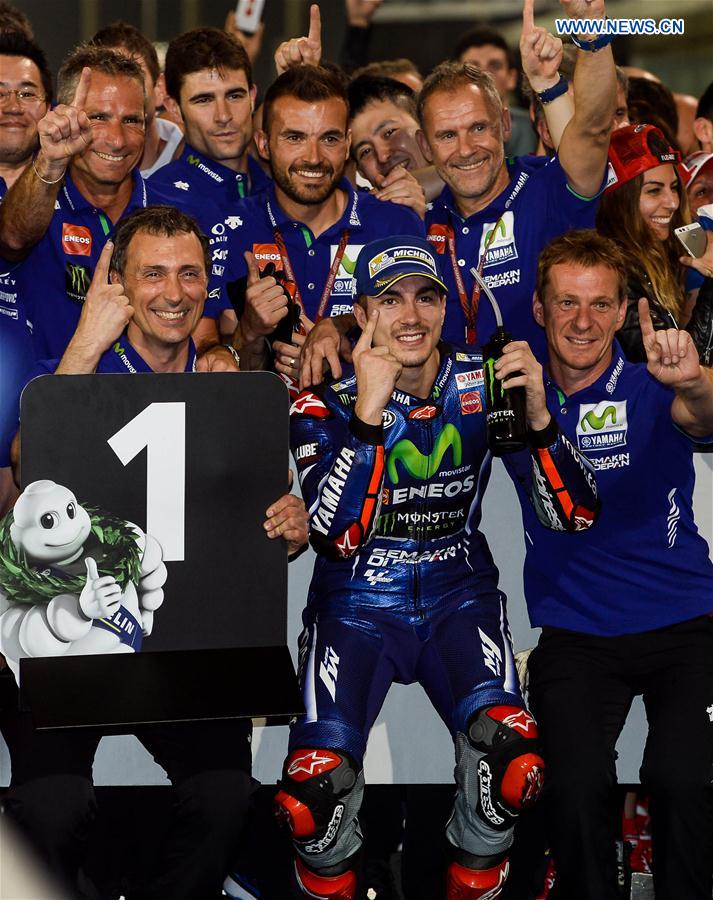 Movistar Yamaha MotoGP's Spanish rider Maverick Vinales(Front, C) celebrates with his team after winning the 2017 FIM MotoGP Grand Prix of Qatar at the Losail International Circuit in Doha, capital of Qatar, on March 26, 2017.