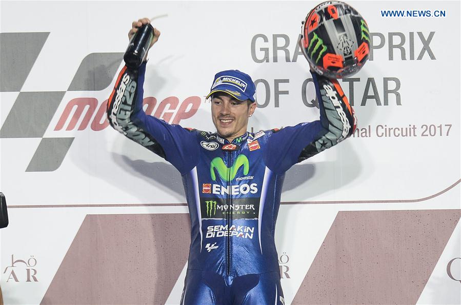 Movistar Yamaha MotoGP's Spanish rider Maverick Vinales celebrates during the awarding ceremony for the 2017 FIM MotoGP Grand Prix of Qatar at the Losail International Circuit in Doha, capital of Qatar, on March 26, 2017. 