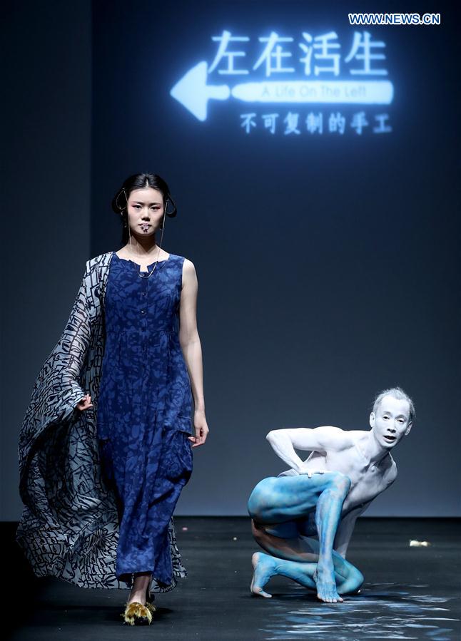 A model presents a creation by Lin Qi at the collection show 'A Life On The Left' during China Fashion Week in Beijing, capital of China, March 26, 2017.