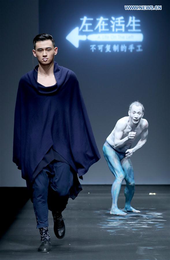A model presents a creation by Lin Qi at the collection show 'A Life On The Left' during China Fashion Week in Beijing, capital of China, March 26, 2017.