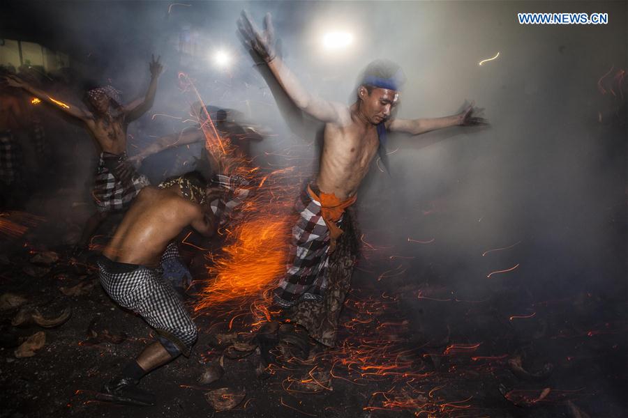 Balinese men take part in Mesabatan Api or the sacred battle of fire at Pakraman Nagi village, in Gianyar, Bali, Indonesia. March 27, 2017, one day before Nyepi, the day of silence.
