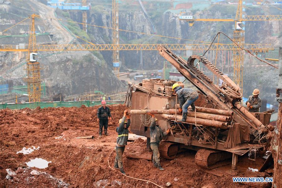 Workers are seen in the construction site of 'Xiangjiang Joy City Snow World' located in an abandoned pit in Changsha, capital of central China's Hunan Province, on March 10, 2017. 