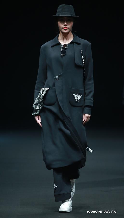 A model presents a creation by Liu Yong during China Fashion Week in Beijing, capital of China, March 30, 2017. 