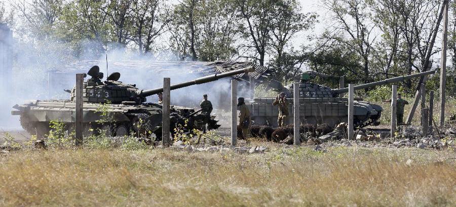 Ukraine withdraws heavy weapons from front line after Paris talks
