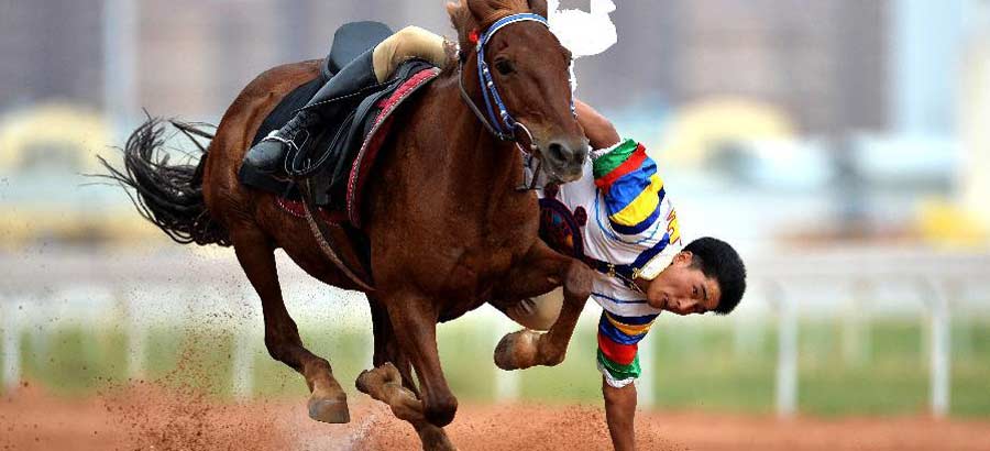 Men on horsebacks at National Traditional Games of Ethnic Minorities