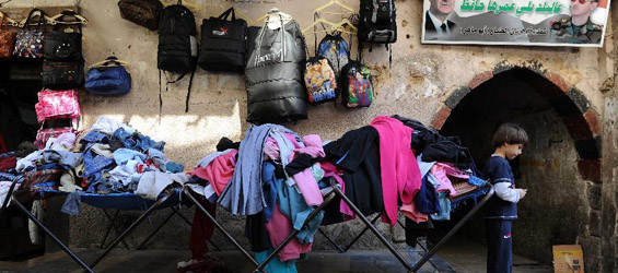 Syrian men deal in second-hand clothes market in Damascus