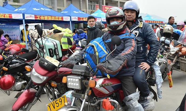 Migrant workers in south China go home by motorcycle during Spring Festival travel rush
