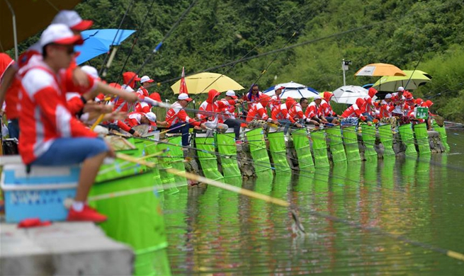 Contestants take part in fishing competition in central China's Hubei