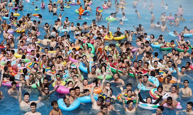 People have fun at water amusement park in Chongqing amid summer heat