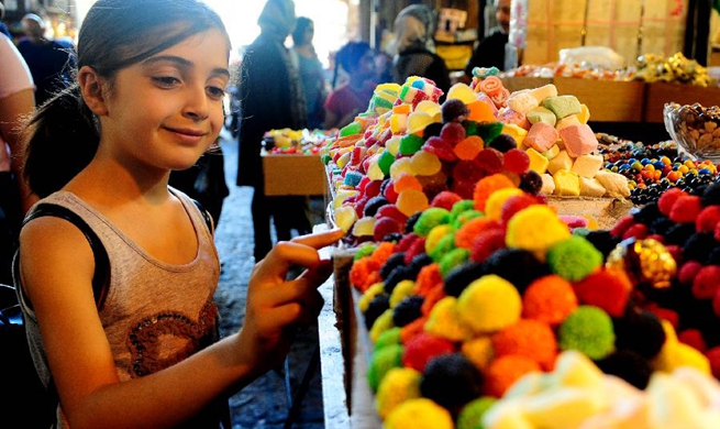 People in Damascus shop for holiday of Eid al-Adha