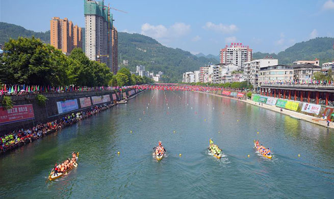 Dragon boat race held in Xuan'en County, central China's Hubei