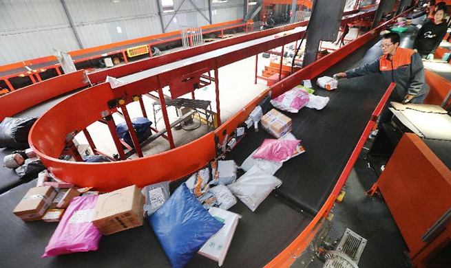 Workers busy dealing with packages during Singles' Day online shopping promotion