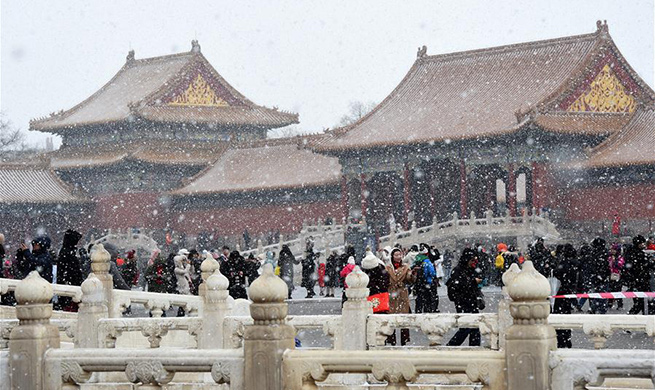 Visitors enjoy snow scenery at Palace Museum in Beijing