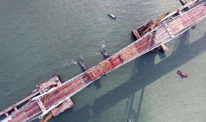 China completes world's longest cross-sea road-rail bridge