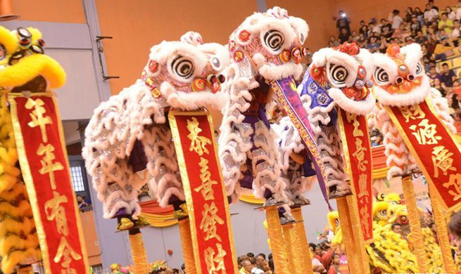 Folk artists perform lion dance to greet upcoming Chinese New Year in Malaysia