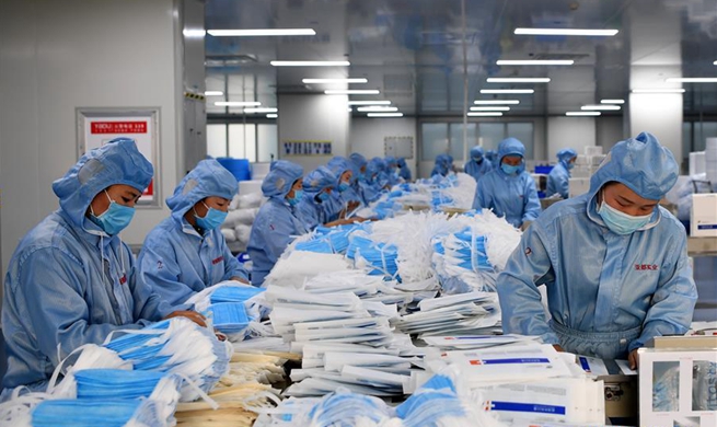 Workers across China rush back to make protective equipment to help fight outbreak of pneumonia