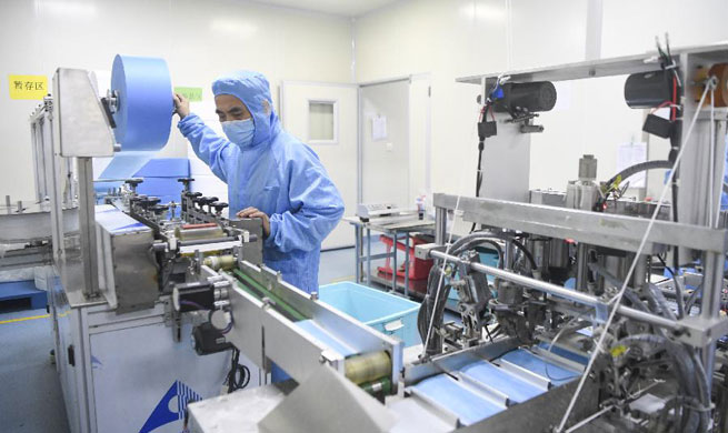 Workers make masks at medical supply company in Chongqing