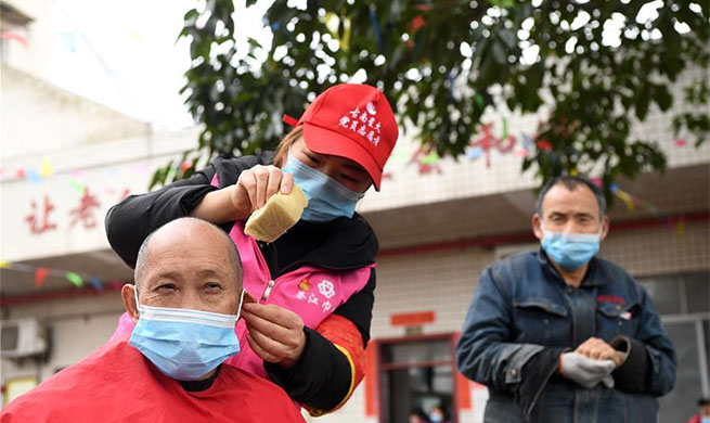Volunteers cut hair for elderly people at elderly care center