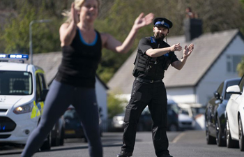 Residents, police officers in Britain dance together amid COVID-19 lockdown