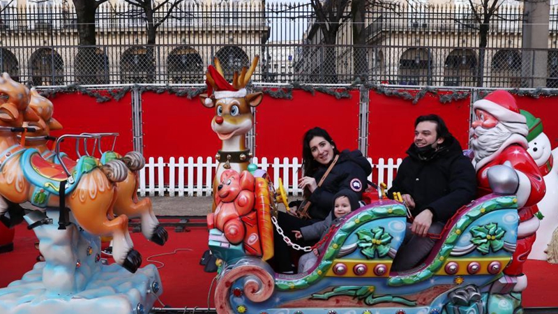 People enjoy themselves at Christmas market in Paris