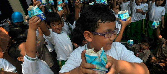 Indonesian students hold milk to mark World School Milk Day