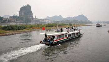 Ships carrying tourists move on Lijiang River in China's Guilin