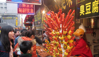 Tourists enjoy snacks at Hubu street in China's Wuhan