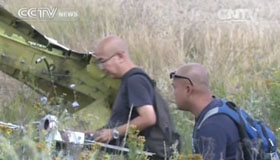 Malaysian investigators inspect crashed plane debris