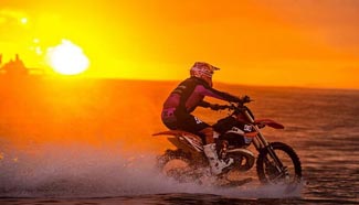 Australian man rides motorcycle in sea