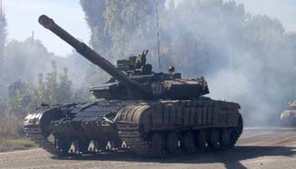 Ukraine withdraws heavy weapons from front line after Paris talks