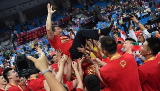 Chinese basketball coach Gong Luming marks victory with players