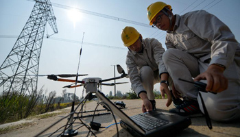 Quad-rotor drone with infrared camera inspects UHV power transmission lines