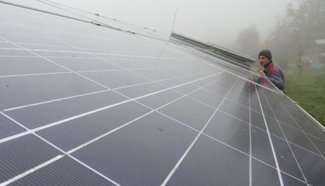 Employee checks panels of solar power plant in BiH