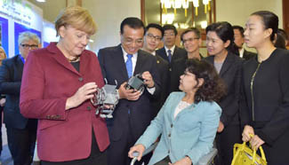 Li Keqiang, Merkel attend meeting on disability in Beijing