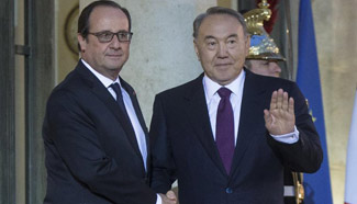 French president shakes hands with Kazakh counterpart in Paris