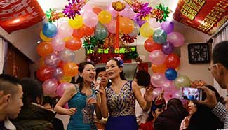 Passengers celebrate Xiaonian Festival on train heading home