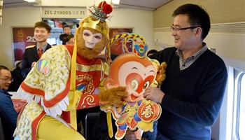 Train crew in Monkey King costume celebrate Chinese Lunar New Year with passengers