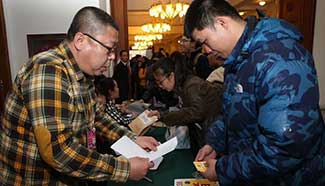 Journalists get credentials at CPPCC auditorium in Beijing