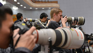 Journalists work during opening meeting of 4th session of 12th CPPCC National Committee