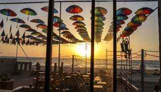 Cafe shop decorated with colorful umbrellas during Ramadan in Gaza
