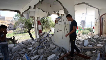 Palestinians inspect rubbles of house demolished by Israeli soldiers