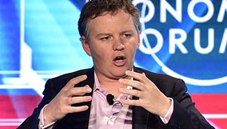 Guests speak during session of Summer Davos Forum