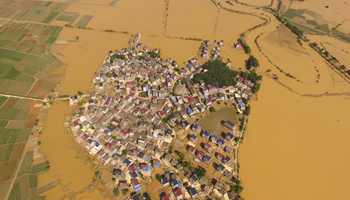 River breaches banks after heavy rain, E China