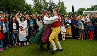 People dance to mark midsummer in Stockholm