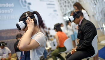 Visitors try at exploration zone on Summer Davos Forum in China's Tianjin