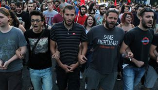 Feature: Greek gov't pledges better days ahead, as few "No" voters protest