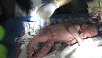 Baby boy delivered at power-cut hospital in flooded central China