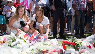 People lay flowers near site of terrorist attack to mourn victims in Nice