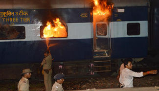 Police try to put out fire on train coach in Patna, India