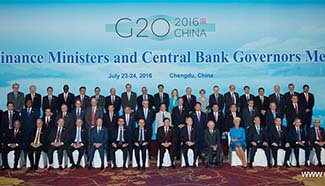 Participants pose for group photo during G20 meeting